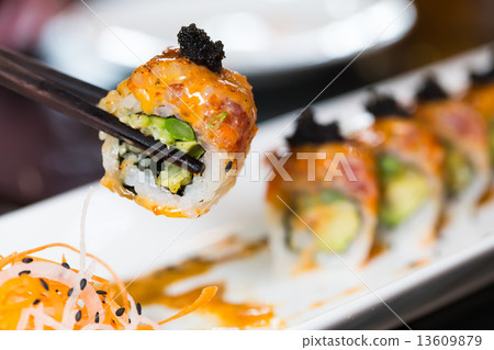 Sushi roll with black chopsticks 13609879