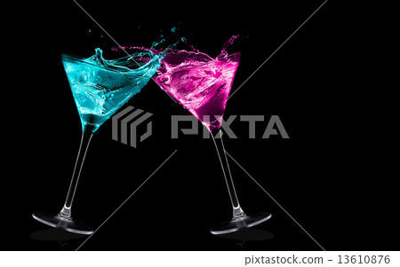 Exotic Liquors. Stemmed cocktail glasses making a toast splashin 13610876