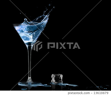 Cocktail Glass with Blue Spirit Drink Splashing. 13610879