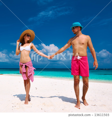 Couple in blue on a beach at Maldives Couple in blue on a beach at Maldives 13611503