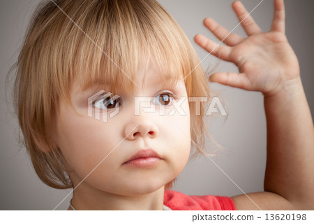Portrait of cute blond baby girl with hand up gesture 13620198