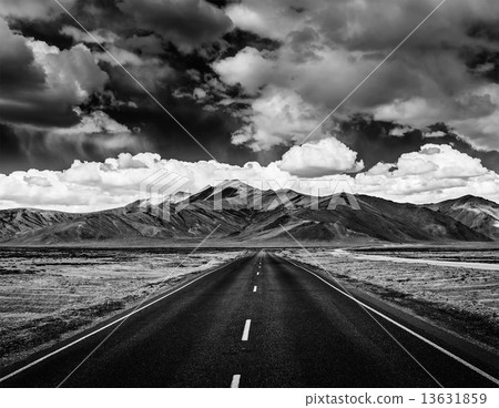 Road on plains in Himalayas with mountains 13631859