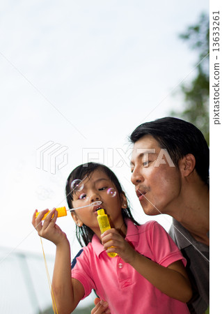 Asian Father and Daughter Playing in the Park Asian Father and Daughter Playing in the Park 13633261