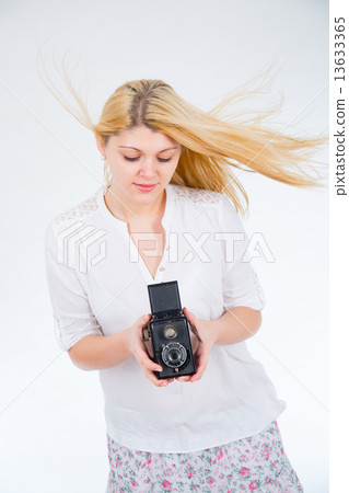 girl on a white background with retro camera 13633365