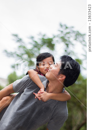 Asian Father Carrying Daughter 13633423