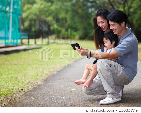 Asian Family in the Park 13633779