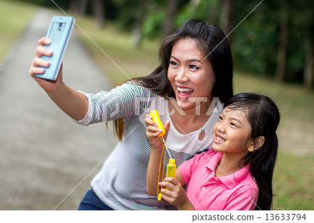 Asian Mother and Daughter in the Park 13633794