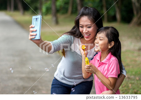Asian Mother and Daughter in the Park 13633795