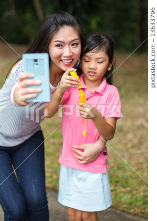 Asian Mother and Daughter in the Park 13633796