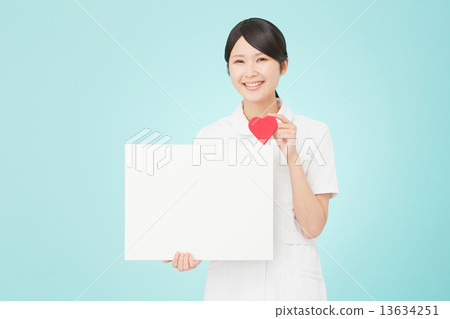 A nurse laughing with a message board and a heart A nurse laughing with a message board and a heart 13634251