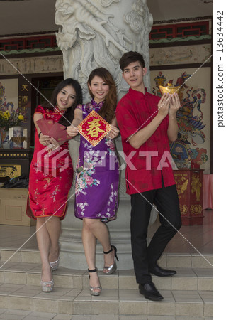 Two girls with Hongbao and greetings man with Yuanbao Two girls with Hongbao and greetings man with Yuanbao 13634442