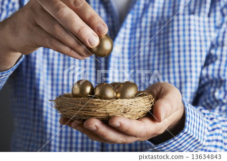 Man Holding Nest Full Of Golden Eggs Man Holding Nest Full Of Golden Eggs 13634843