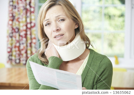 Woman Reading Letter After Receiving Neck Injury Woman Reading Letter After Receiving Neck Injury 13635062