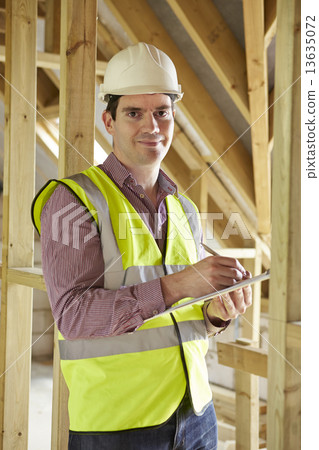 Building Inspector Looking At New Property 13635072
