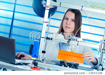 Stock Photo: A student girl print prototype on 3D printer