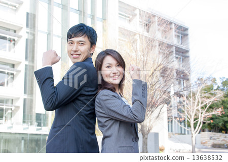 A male and female employee who plays guts pose A male and female employee who plays guts pose 13638532