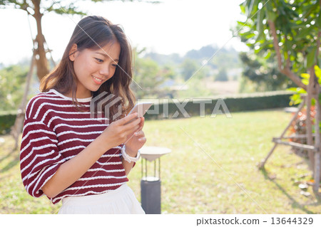 portrait of young beautiful woman reading message text on mobile 13644329