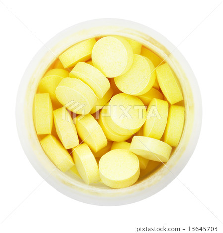 top view of yellow pills in round plastic bottle 13645703
