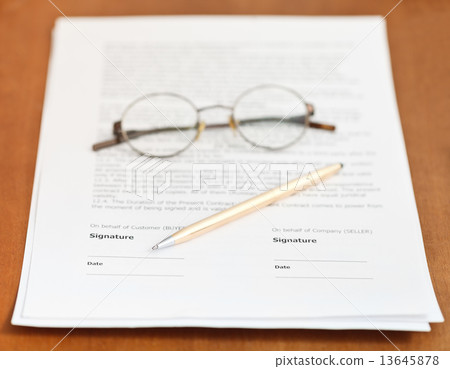 contract, golden pen and eyeglasses on table 13645878
