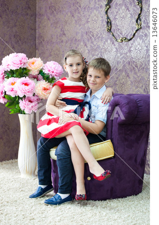 boy and girl sitting in the nice room 13646073