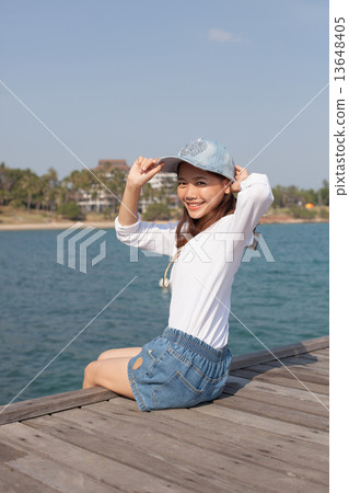 portrait of beautiful woman happy face sitting on wood port sea 13648405