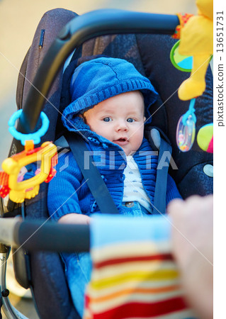 Little boy in stroller playing with toys 13651731