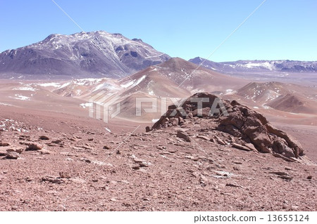 Land of desolate sand and rock illuminated by strong sunlight of the Andes highland of South America 13655124