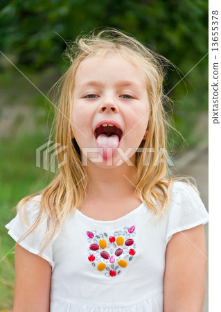 Cute girl with put out tongue 13655378