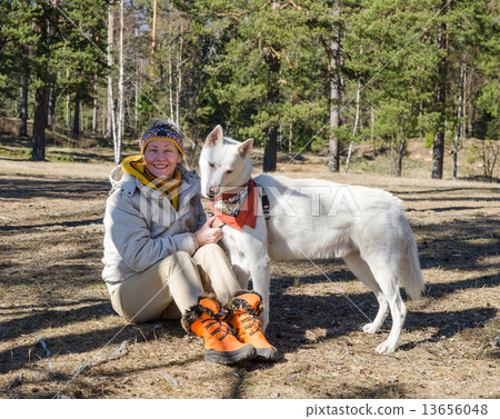 The woman with a white dog in a wood The woman with a white dog in a wood 13656048