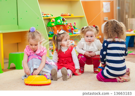 Little girls playing with toys in the playroom 13663183