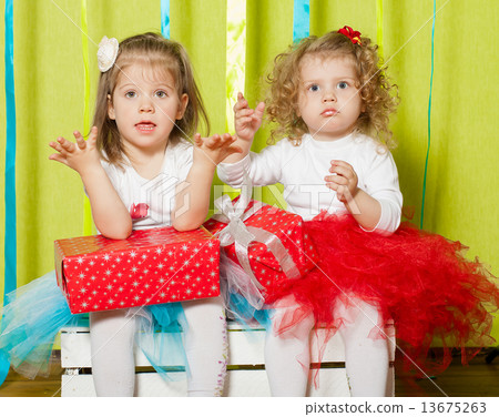 Little girls in fluffy skirts with gift boxes in hands 13675263