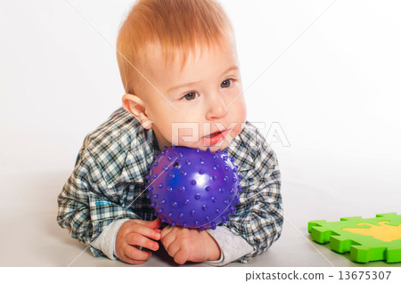 Baby boy playing with colorful toys Baby boy playing with colorful toys 13675307