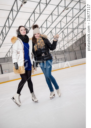 Two girls on ice-skating rink 13677117