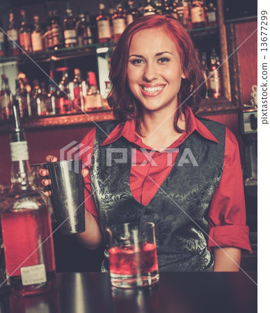 Beautiful redhead barmaid making cocktail Beautiful redhead barmaid making cocktail 13677299