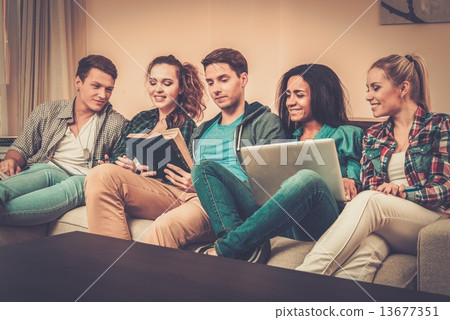 Group of students preparing for exams in apartment interior Group of students preparing for exams in apartment interior 13677351