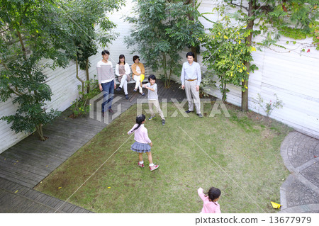 Three generation family playing in the garden 13677979