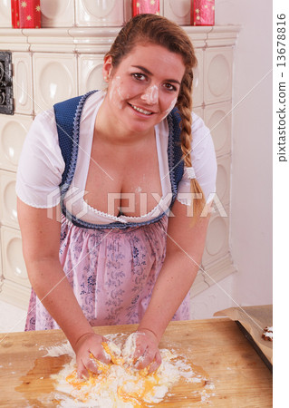 Young girl with deep neckline kneads dough and has flour on her face and chest Young girl with deep neckline kneads dough and has flour on her face and chest 13678816