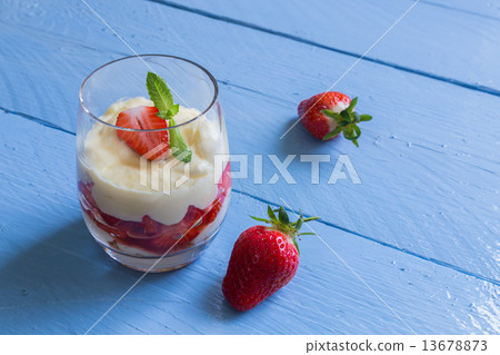 Vanilla pudding with tipsy strawberries on wood Vanilla pudding with tipsy strawberries on wood 13678873