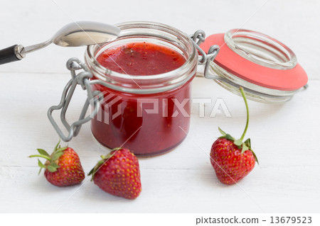Strawberry jam in a jar on wood 13679523