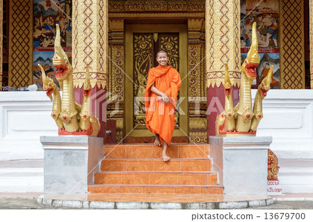 Young Buddhist Monk Walking In Front Of Monastery Young Buddhist Monk Walking In Front Of Monastery 13679700