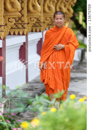 Young Buddhist Monk Walking Next To The Temple Young Buddhist Monk Walking Next To The Temple 13679709
