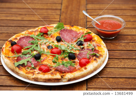 Delicious italian pizza served on wooden table 13681499