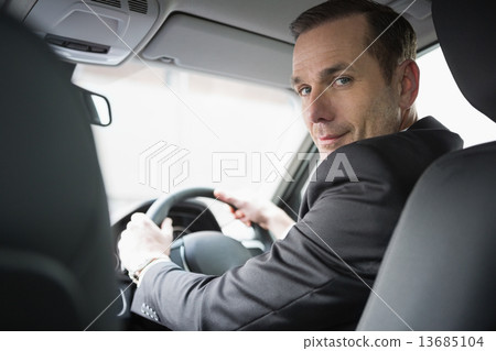 Handsome businessman looking at camera Handsome businessman looking at camera 13685104