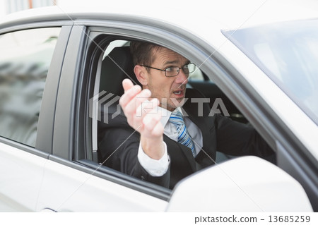Handsome businessman experiencing road rage 13685259
