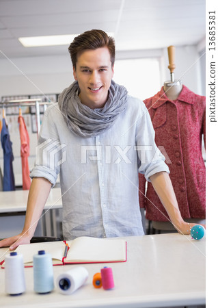 Smiling student posing in classroom 13685381