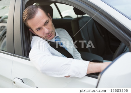 Handsome businessman smiling at camera Handsome businessman smiling at camera 13685396