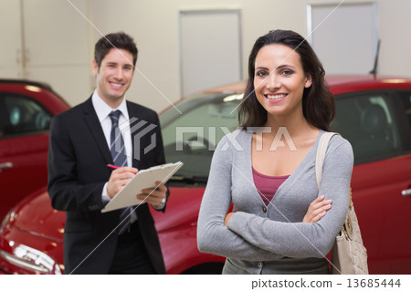Smiling businessman undersign a car contract Smiling businessman undersign a car contract 13685444
