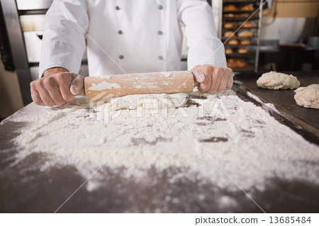 Close up of baker using a rolling pin 13685484