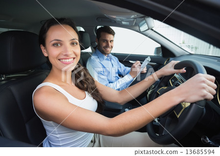 Young woman getting a driving lesson 13685594