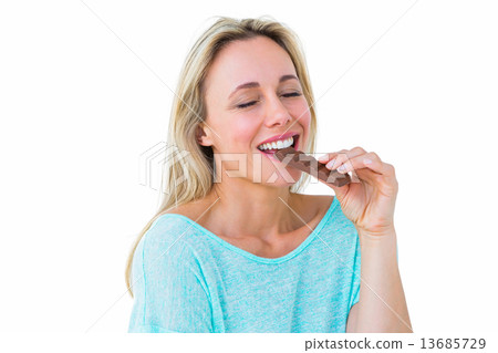 Pretty blonde enjoying and eating bar of chocolate Pretty blonde enjoying and eating bar of chocolate 13685729